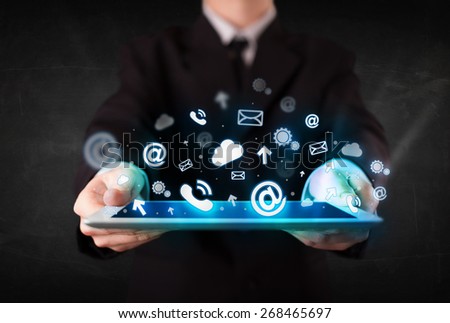 Person holding a white tablet with blue technology icons and symbols
