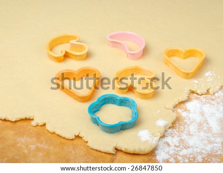 Mixed cookie cutters on wooden table