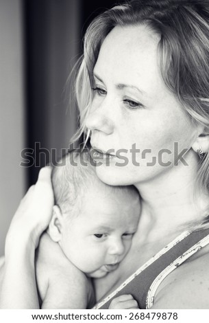 Mother with newborn baby child family home black and white