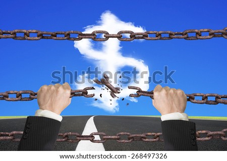 Rusty iron chains broken off by hands with dollar sign shape white clouds on sky asphalt road background
