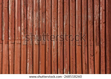 Old and weathered red painted wooden wall