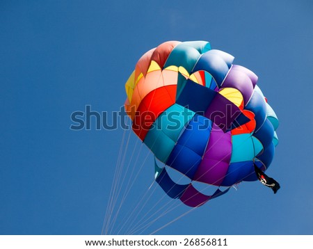 Closeup of a multicolor parasailing balloon with pirate flag and beautiful blue sky in background.