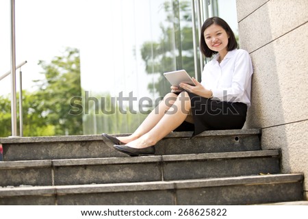 Asian young female executive holding a tablet