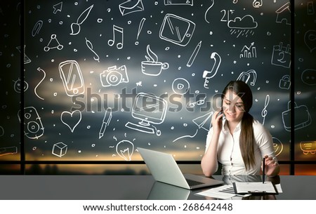 Businesswoman sitting at table with hand drawn social media icons and symbols
