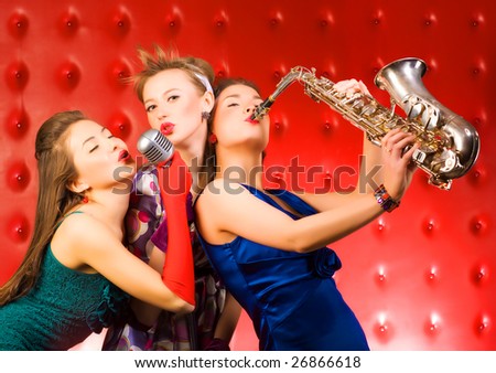 Musical band. Three singing women.