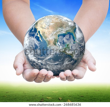 World environment day concept: Earth globe in human hands on nature background. environment concept. Elements of this image furnished by NASA