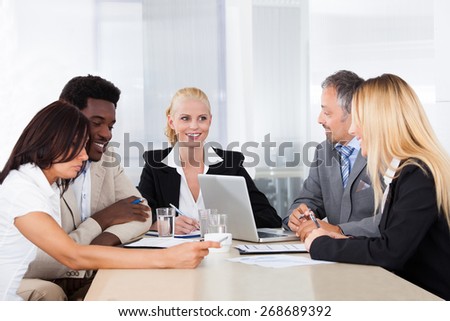 Group Of Multi Ethnic Businesspeople Discussing Together In Office