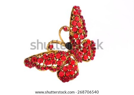 brooch in the form of a butterfly on a white background Royalty-Free Stock Photo #268706540