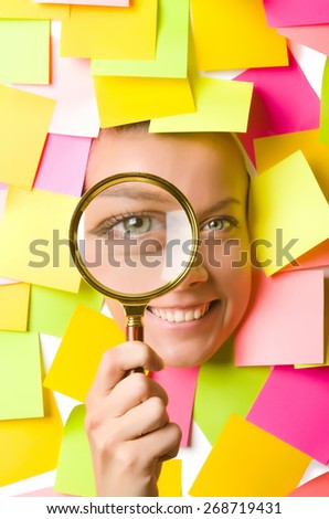 Woman with reminder notes and magnifying glass