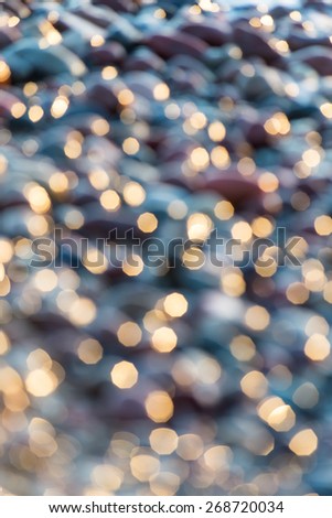 out of focus blur background with sea water in sunset light