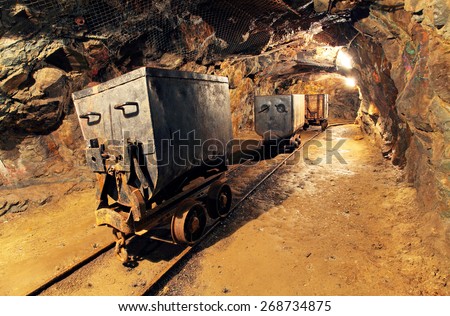 Mining cart in silver, gold, copper mine Royalty-Free Stock Photo #268734875