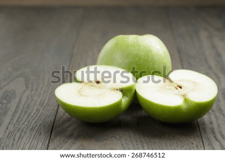 green sour apple on wood table sliced