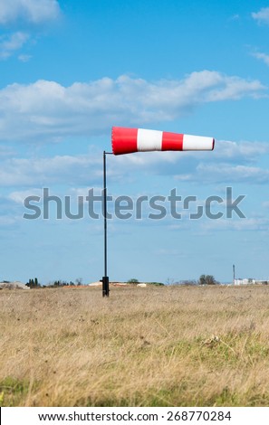 Wind flag windsock on the background of blue sky airport
