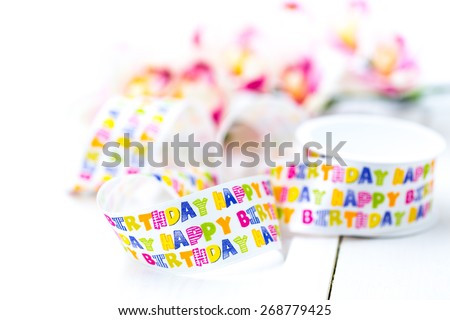 A detail of a happy birthday ribbon reel