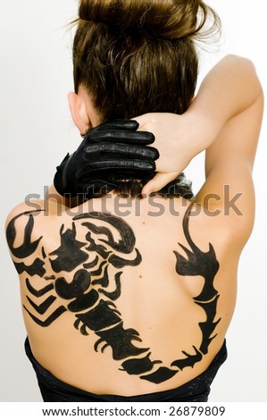 Girl with black scorpio sign painted on back and face
