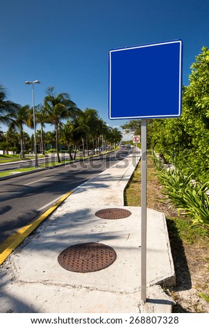 Empty blue road sign. Tropical street