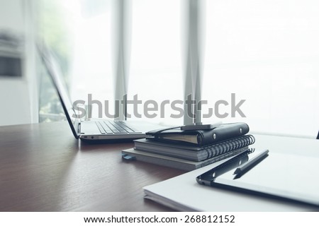 Office workplace with laptop and smart phone on wood table Royalty-Free Stock Photo #268812152