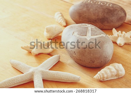 Close up of collection of nautical and beach objects over wooden background