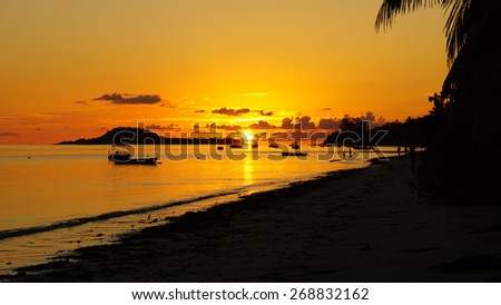 sunset in red and orange on tropical beach