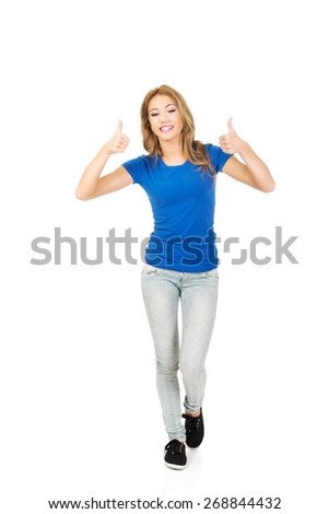 Young beautiful happy woman with thumbs up.