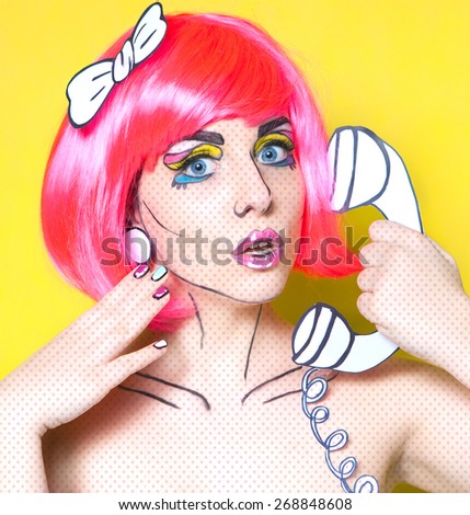 Photo of surprised young woman with a phone and professional comic pop art make up and accessories