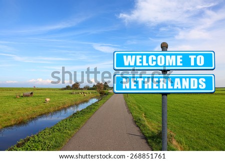 Blue road sign "Welcome to Netherlands" - the invitation to the Netherlands ( visit and travel) against the Dutch meadow landscape 