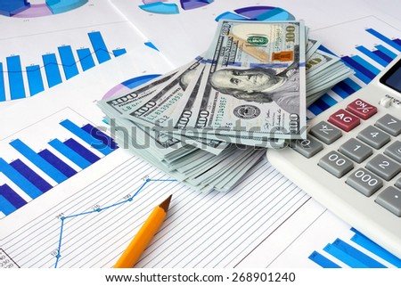 Dollars and calculator on documents. Financial planning concept.