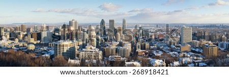 Panorama of Montreal in winter, as seen from Mont Royal. Downtown district with St Lawrence River in the background. early evening light.