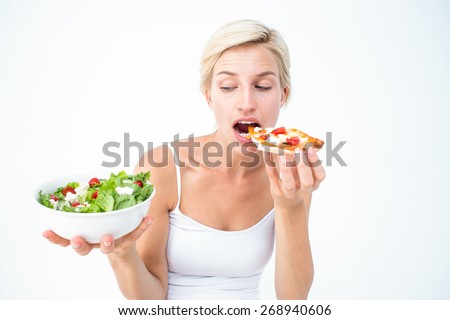 Pretty woman deciding eating pizza rather the salad on white background