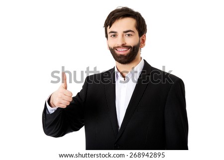 Happy smiling businessman with thumbs up gesture.