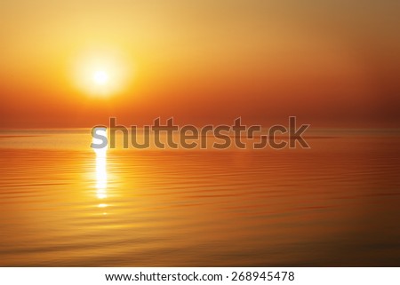 Beautiful sunset over the ocean. Sunrise in the sea  Royalty-Free Stock Photo #268945478