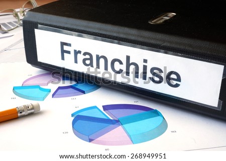 Graphs and file folder with label  franchise. Business concept.