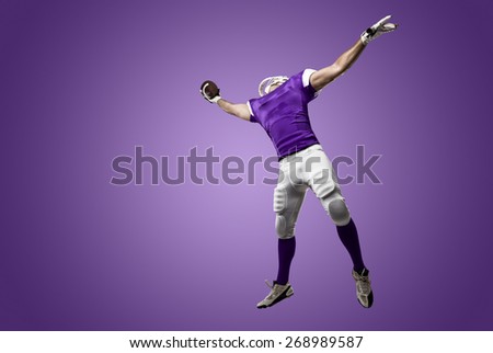 Football Player with a purple uniform making a catch on a purple background.