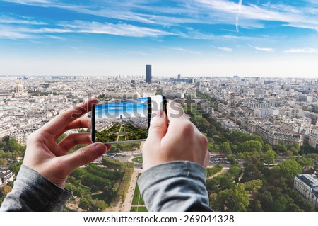 Tourist taking a picture of Aerial panoramic view of Paris. France