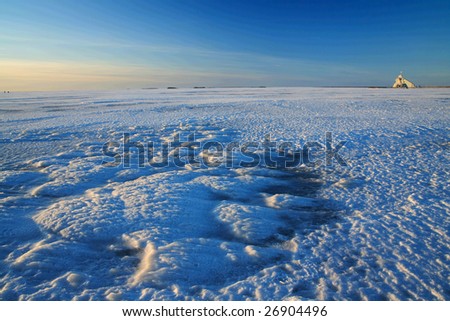 Sunset over frozen lake in winter, Finland