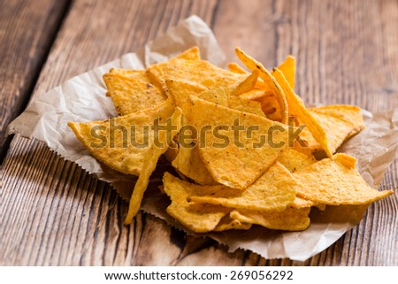 Spicy Nachos (close-up shot) on rustic wooden background