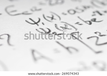 sheet of paper filled with calculations of nuclear and quantum physics as a background