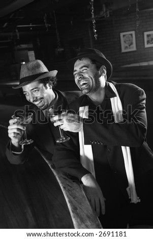 Caucasian prime adult retro males sitting at bar drinking.