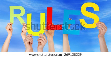 Many Caucasian People And Hands Holding Colorful  Letters Or Characters Building The English Word Rules On Blue Sky