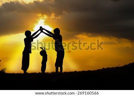 Three brothers, boys play at sunset. Royalty-Free Stock Photo #269160566