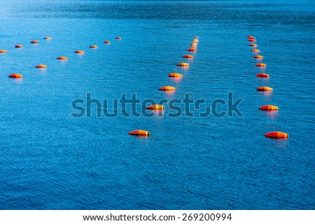 Many fishing red buoys floating on the sea