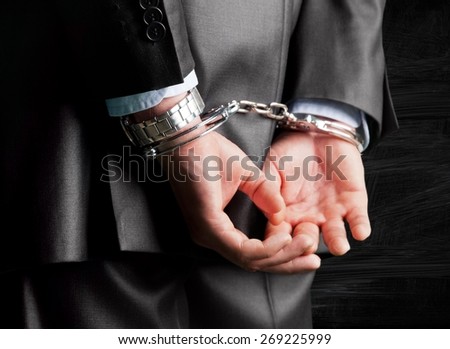Handcuffs, Arrest, White Collar Crime. Royalty-Free Stock Photo #269225999