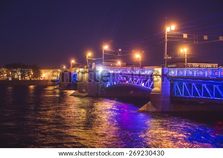 Beautiful night panoramic picture of Saint-Petersburg, Russia, with most famous Palace Bridge with beautiful illumination, palace embankment, with Saint Isaac's Cathedral and Neva river 