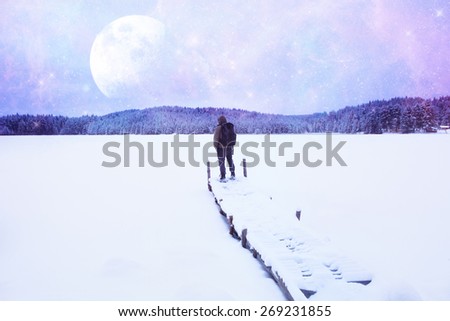 fantasy unusual landscape with man watching stars and big moon in the alien planet- elements of this image are furnished by NASA