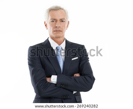 Waist up portrait of senior executive businessman looking at camera while standing against white background.  Royalty-Free Stock Photo #269240282