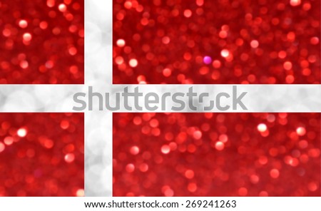 The National flag of Denmark made of bright and abstract blurred backgrounds with shimmering glitter