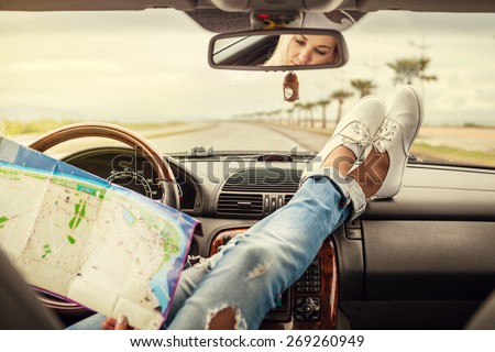 Young woman alone car traveler with map  Royalty-Free Stock Photo #269260949