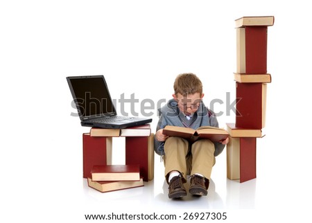 Eight year young boy, prodigy casual dressed, studying next to stack of books and laptop.  White background, studio shot.