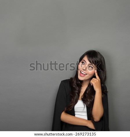 portrait of a asian businesswoman smile looking up to copyspace
