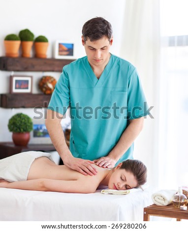 Portrait of massagist working with his client Royalty-Free Stock Photo #269280206